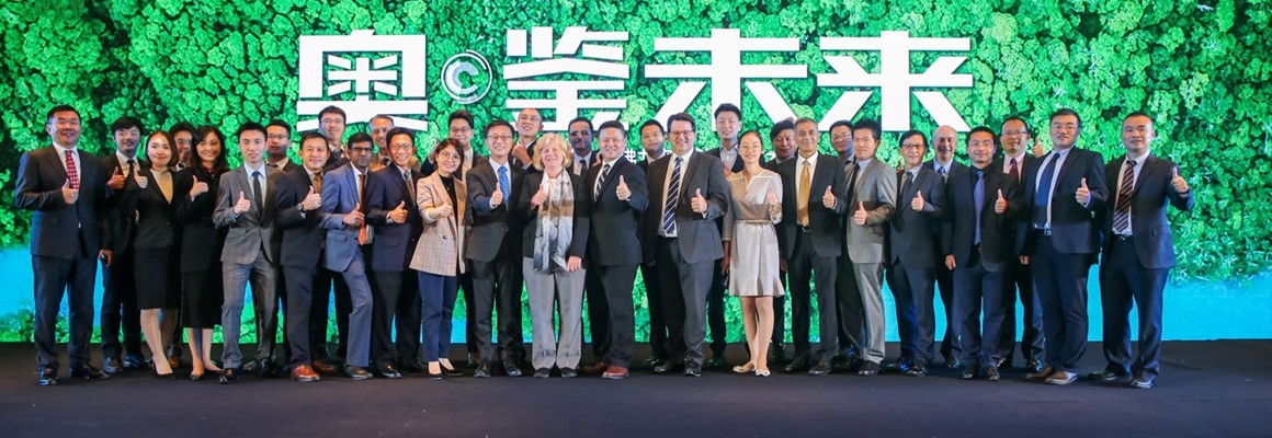 Group portrait of Oronite employees all giving the thumbs-up at an industry event.
