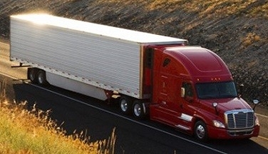 Heavy duty truck driving on highway.