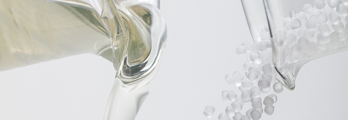 Viscosity modifiers pouring out of two laboratory beakers.